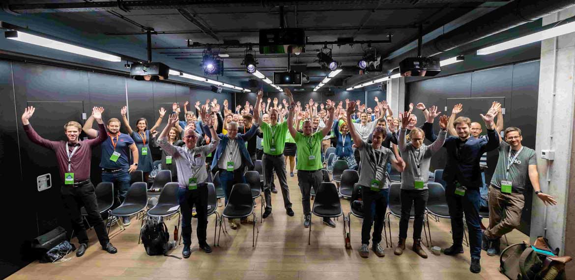 Members of the Sanae team at their EuroSTAR meet-up waving their hands in the air