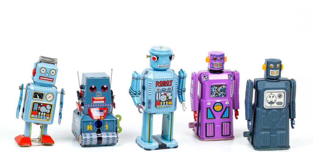 Line-up of robot toys against a white background