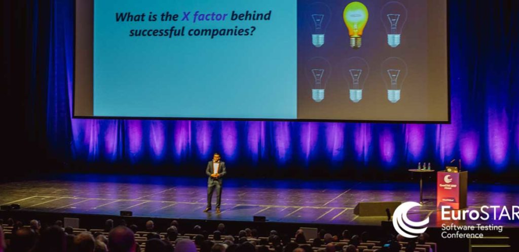 Faraway shot of a EuroSTAR speaker on stage in Prague giving a talk