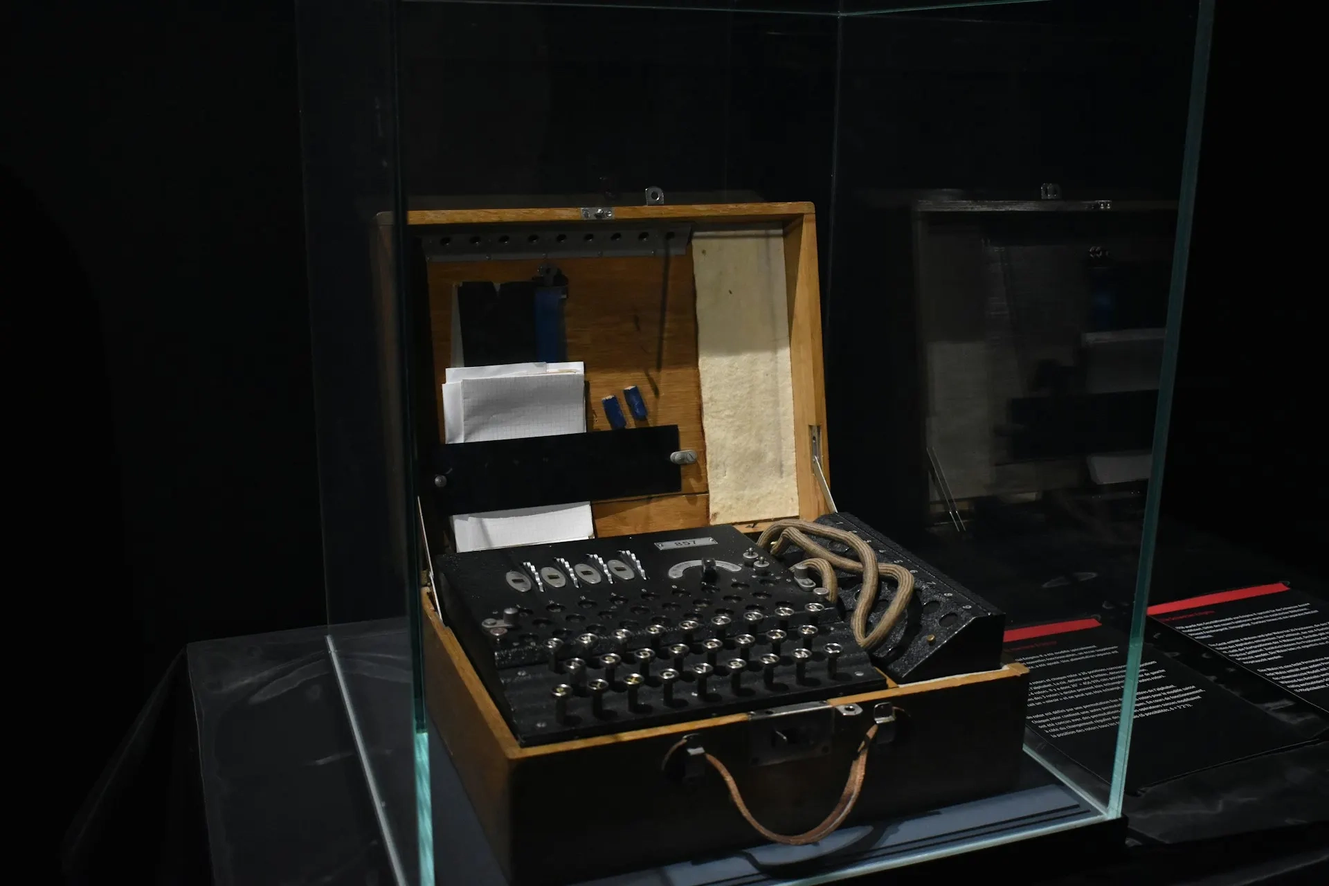 A vintage typewriter on a wooden desk, accompanied by an open notebook and a dimly lit background, evoking a nostalgic and classic writing atmosphere.