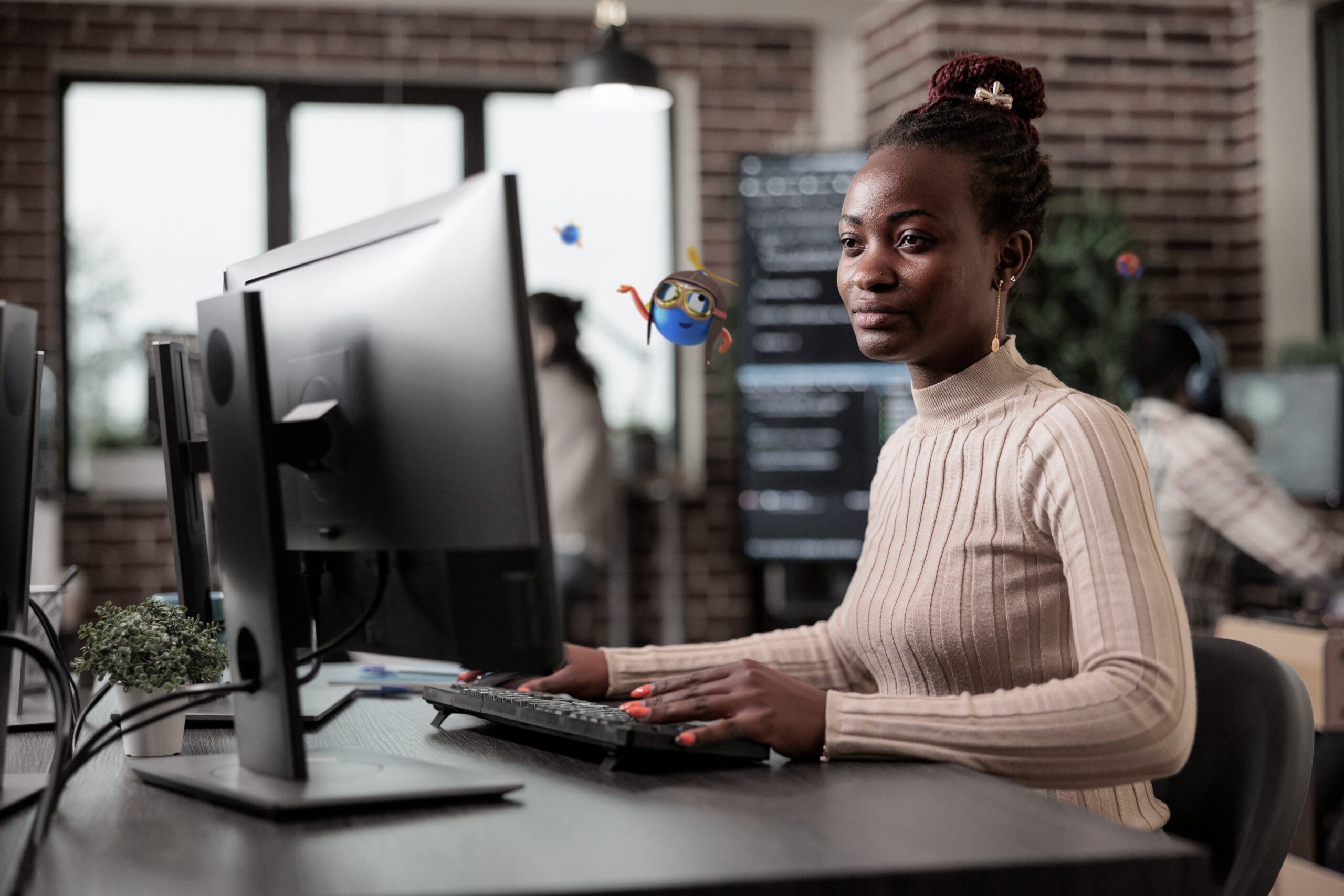 Woman working on a computer as her desk